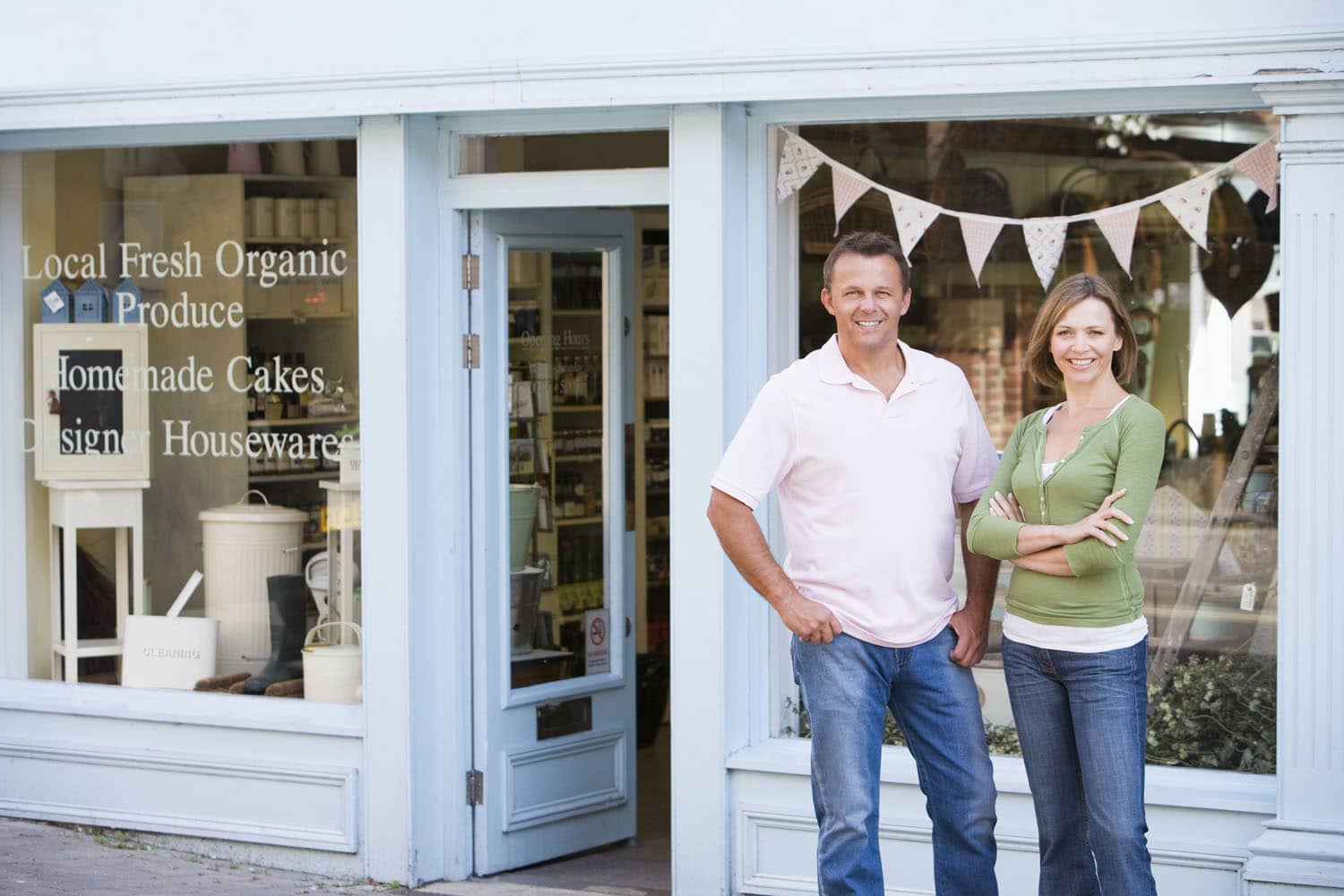 Couple standing in front of their store.